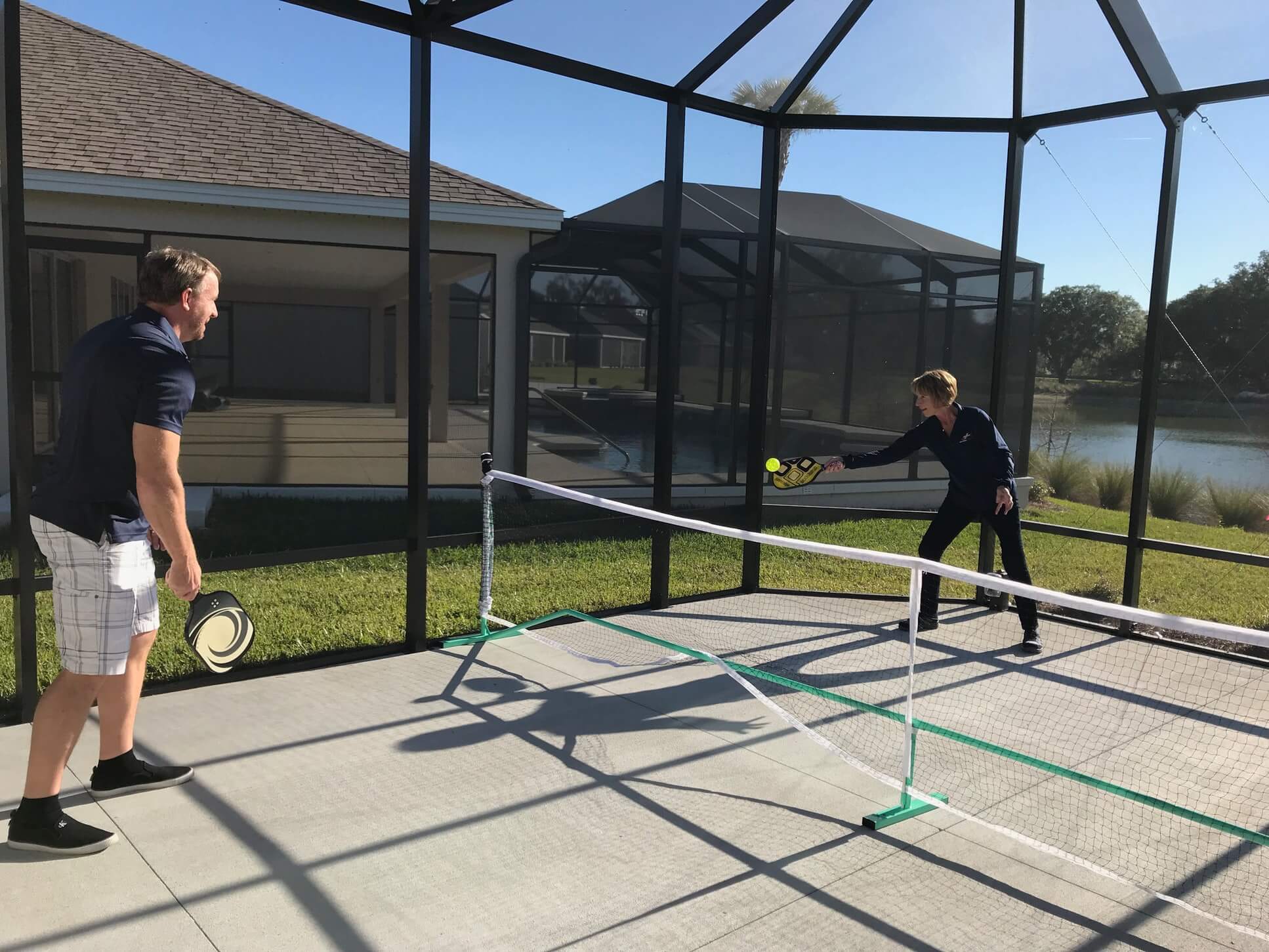 man and woman playing pickleball