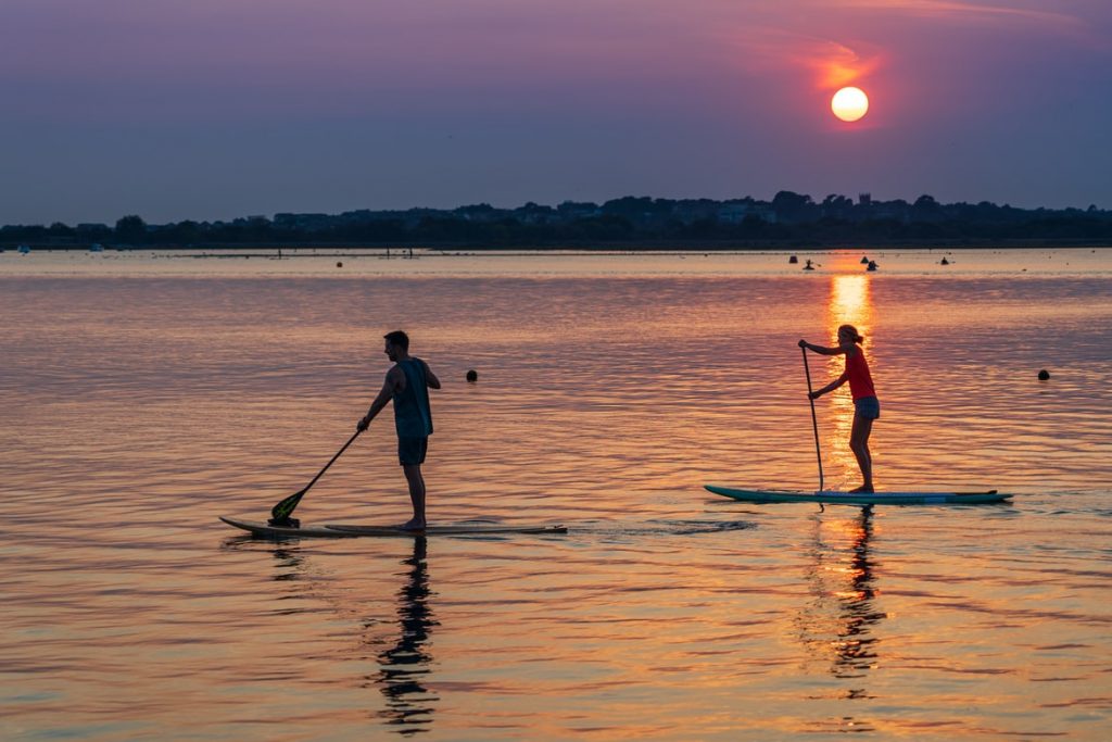 man and women paddle boarding