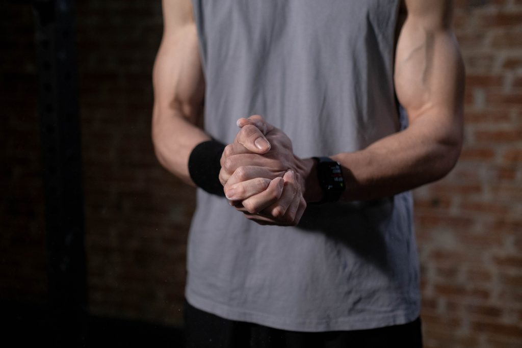 Man having close grip of his hands before training