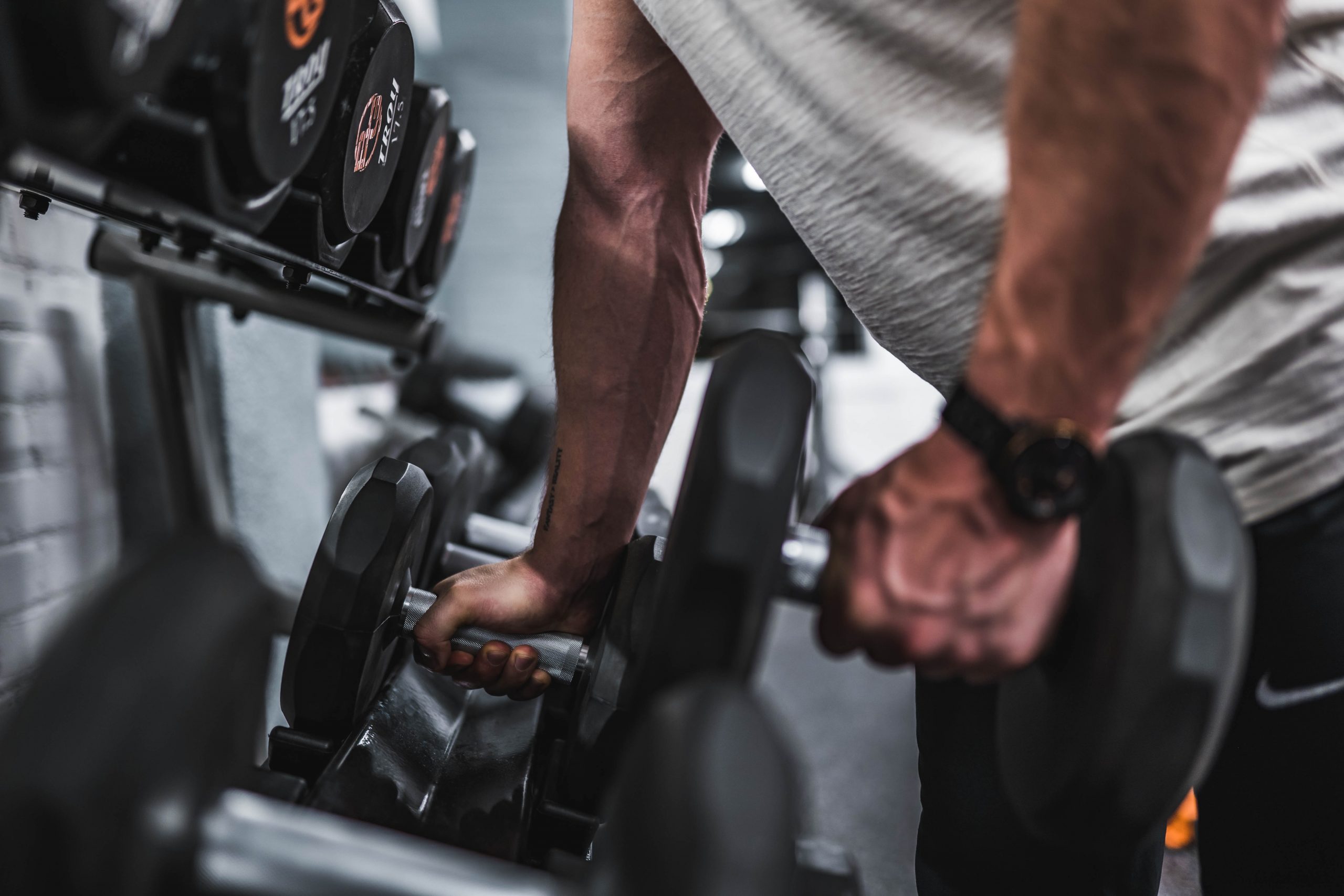 body builder grabbing dumbbells