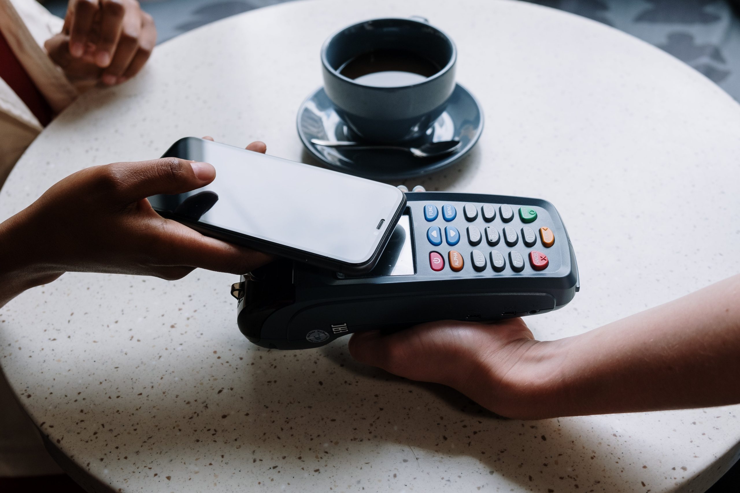 Person Paying with his Black iPhone